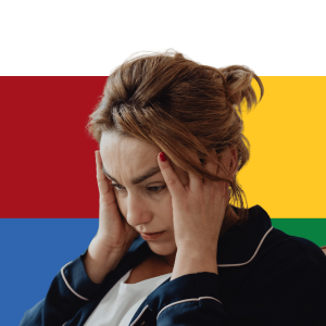 Woman with head in hands looking downward against colorful background, representing stress or mental health concerns