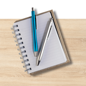 Assorted pens, notepads, and Blu Tack adhesive arranged on orange and yellow background