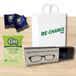 Recharge Populi branded tote bag with Sleep herbal infusion tea, blue light blocking glasses, and popcorn displayed together