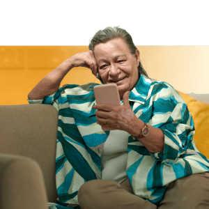 Woman smiling while holding a smartphone, representing digital access to employee assistance programs