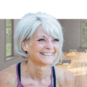 Woman with white hair smiling at camera, wearing purple athletic top against blue background
