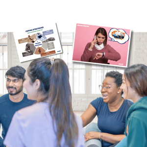 Group of adults in workplace discussion with displayed posters on character values including honesty, family, and healthy coping strategies